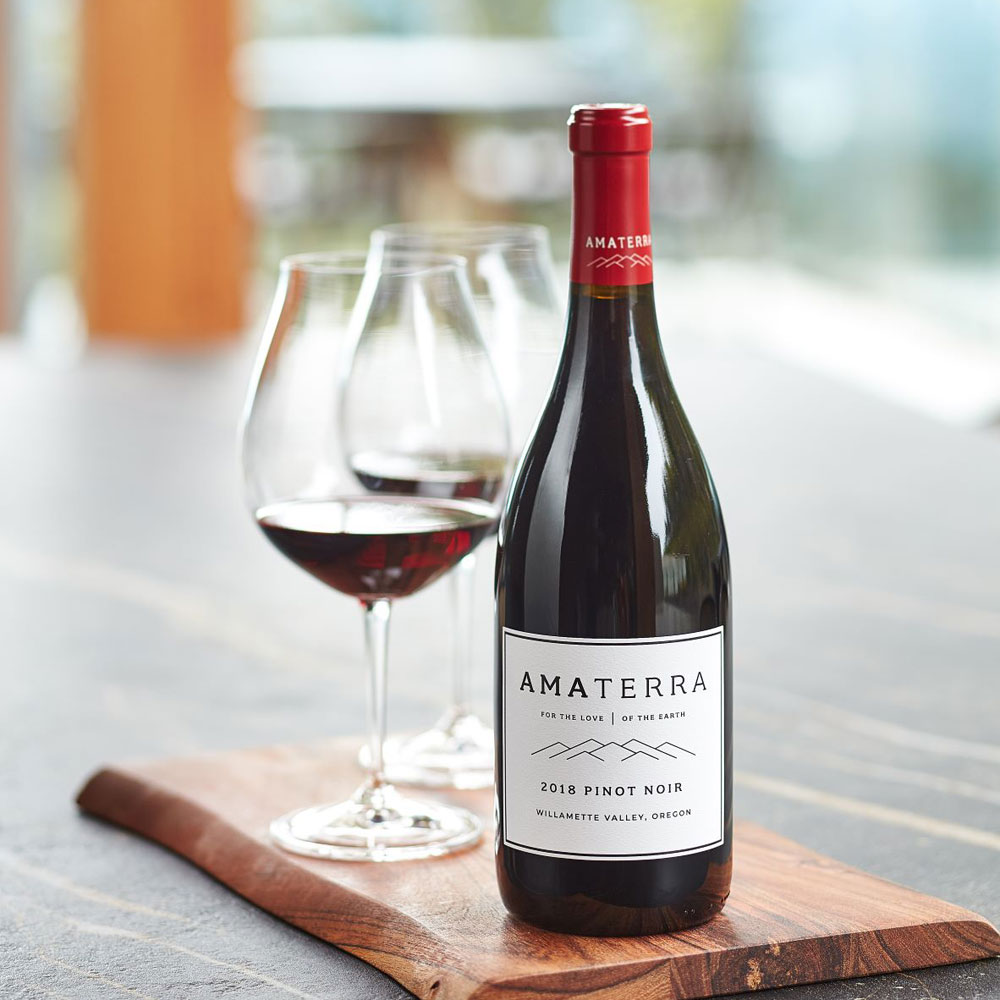 Amaterra wine bottle with two glasses of wine.